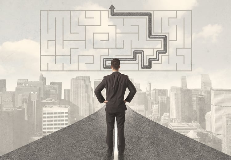 Businessman looking at road with maze and solution concept.jpeg