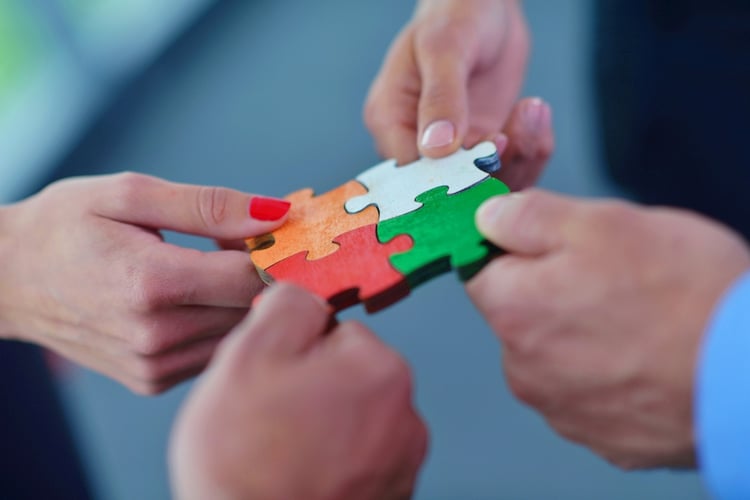 Group of business people assembling jigsaw puzzle and represent team support and help concept.jpeg