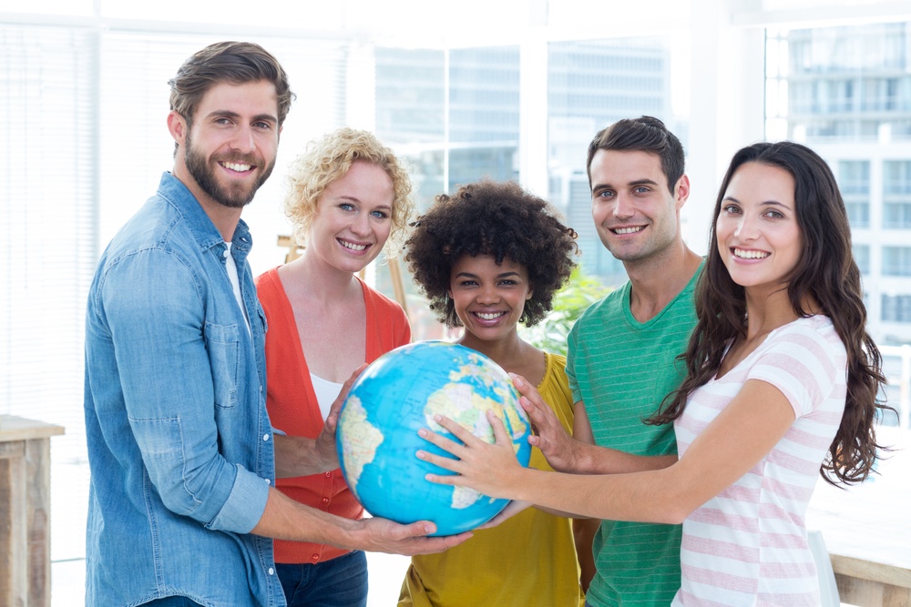 Young creative business people with a globe in the office